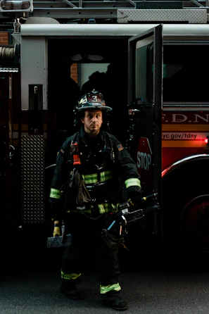 a firefighter standing in front of a fire truck