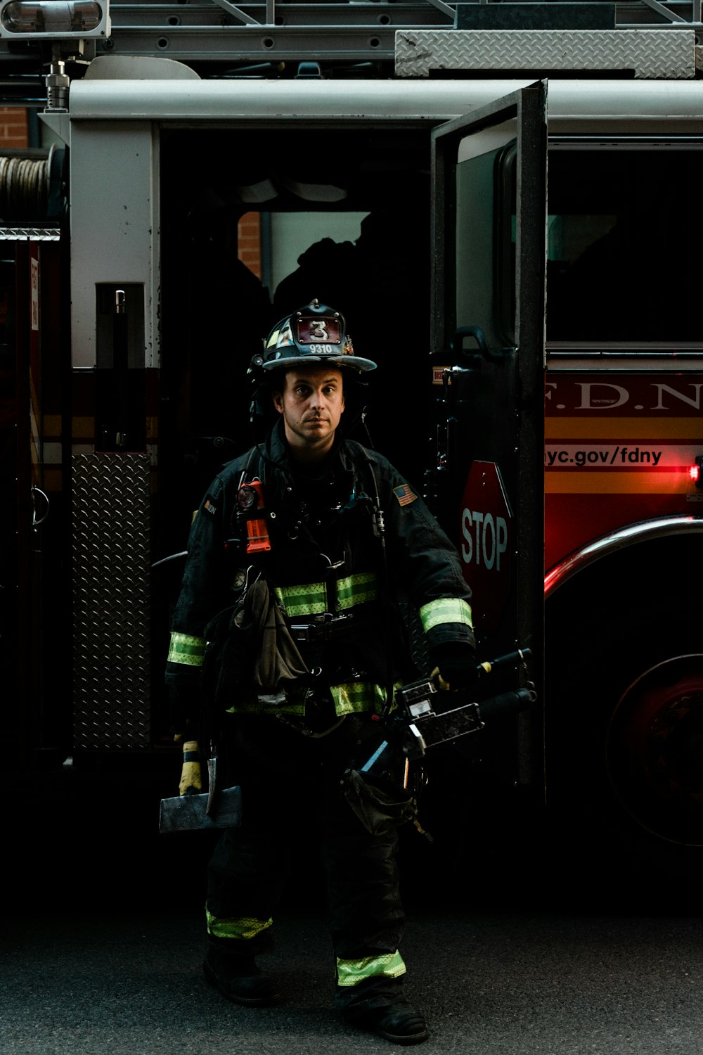 a firefighter standing in front of a fire truck