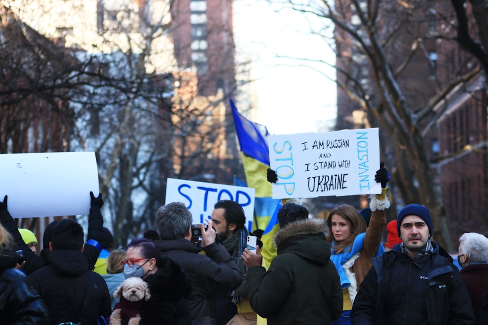 a group of people holding signs in the street