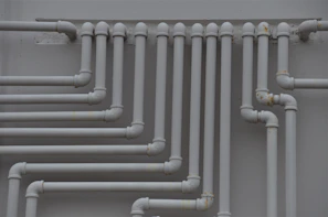 a close up of a bunch of pipes on a wall