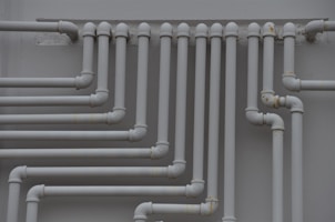 a close up of a bunch of pipes on a wall
