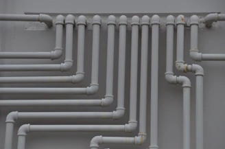 Experienced plumber inspecting old pipes on University Street, Amman.
