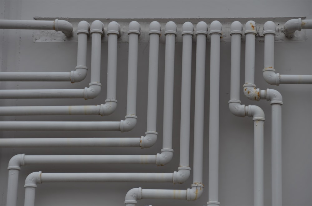 a close up of a bunch of pipes on a wall