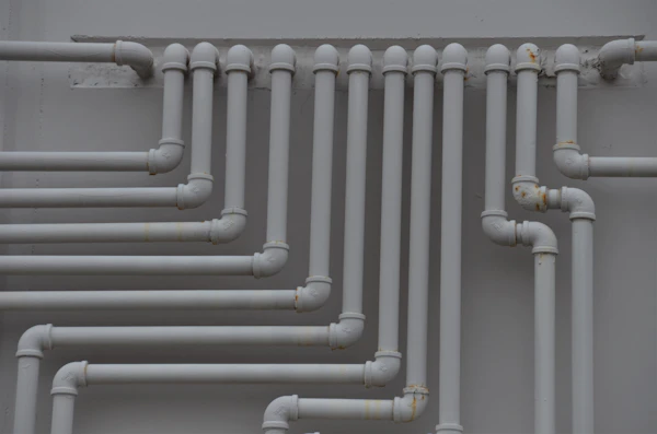 What Happens During Rough Plumbing: a close up of a bunch of pipes on a wall