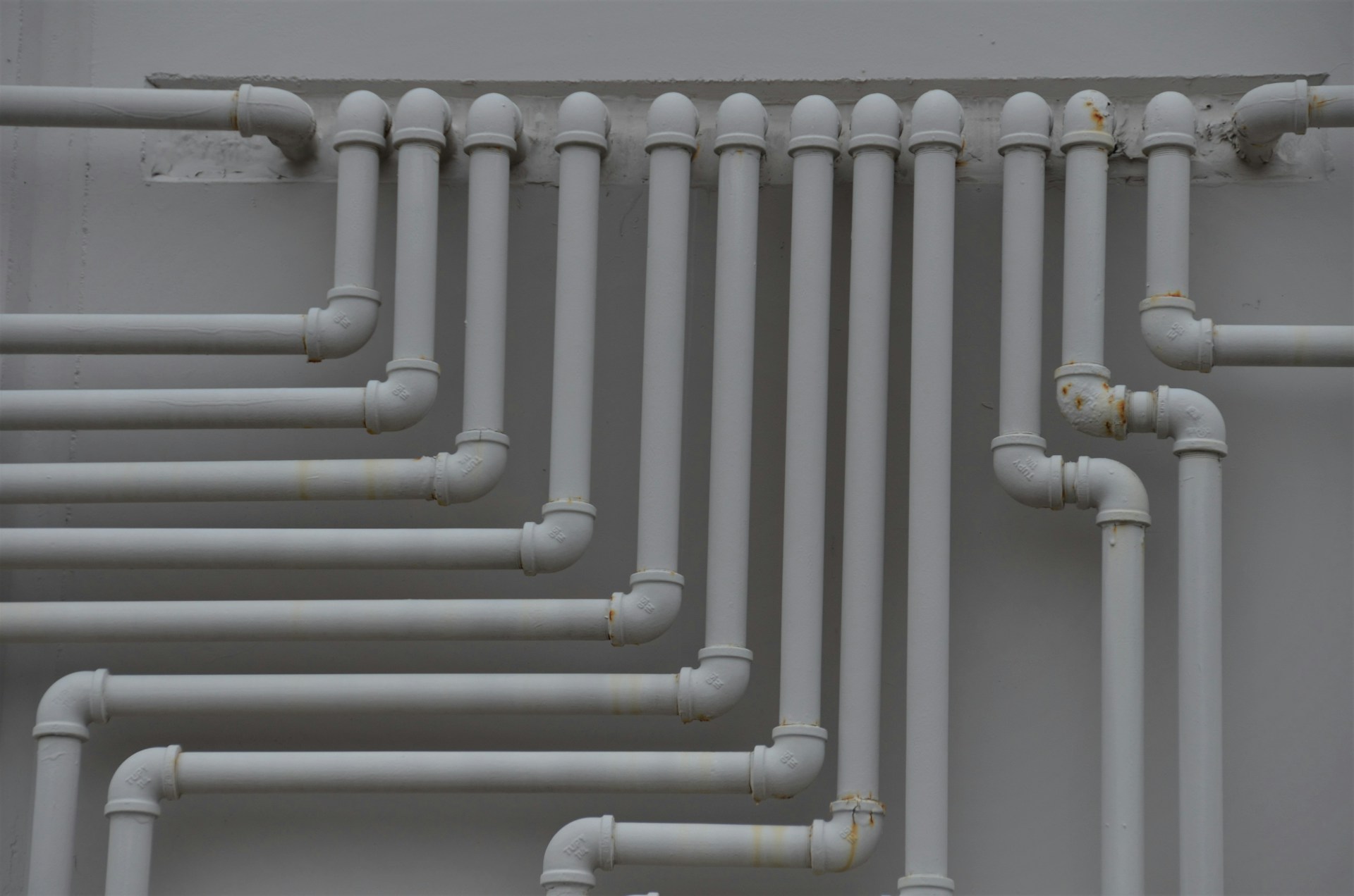 a close up of a bunch of pipes on a wall