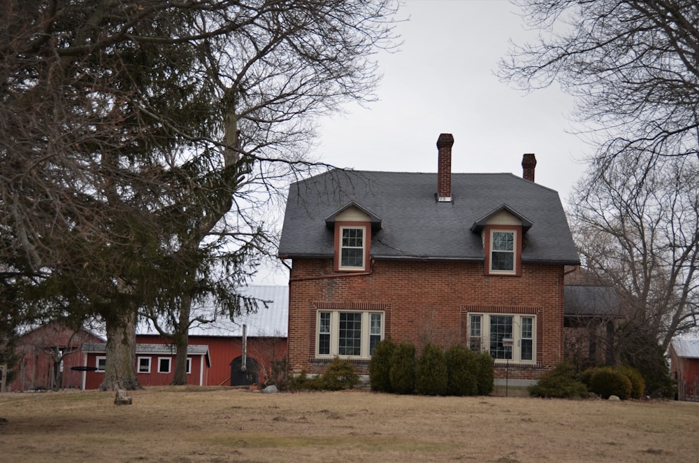 a red brick house with a gray roof