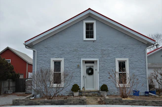 a blue house with a wreath on the front door
