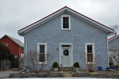 a blue house with a wreath on the front door