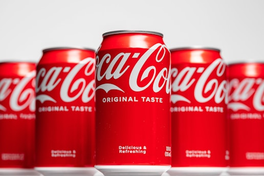 a row of coca - cola cans sitting on top of each other