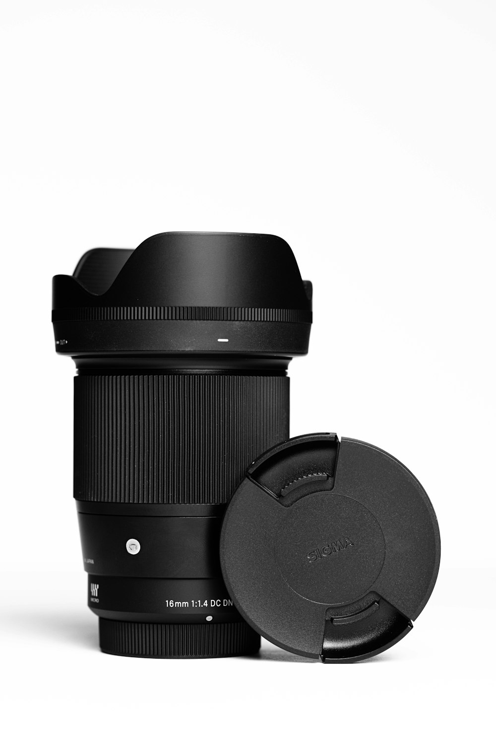 a camera lens with a lens cap next to it