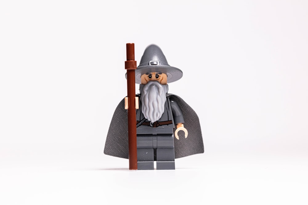 a lego wizard with a staff and a hat