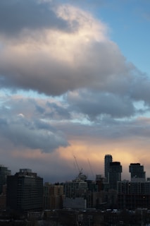 A bustling city skyline at dawn with cranes and industrial plants silhouetted against the rising sun, reflecting the dynamic sectors core jobs serves in India.