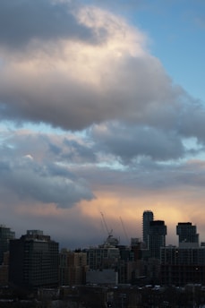 A bustling city skyline at dawn with cranes and industrial plants silhouetted against the rising sun, reflecting the dynamic sectors core jobs serves in India.