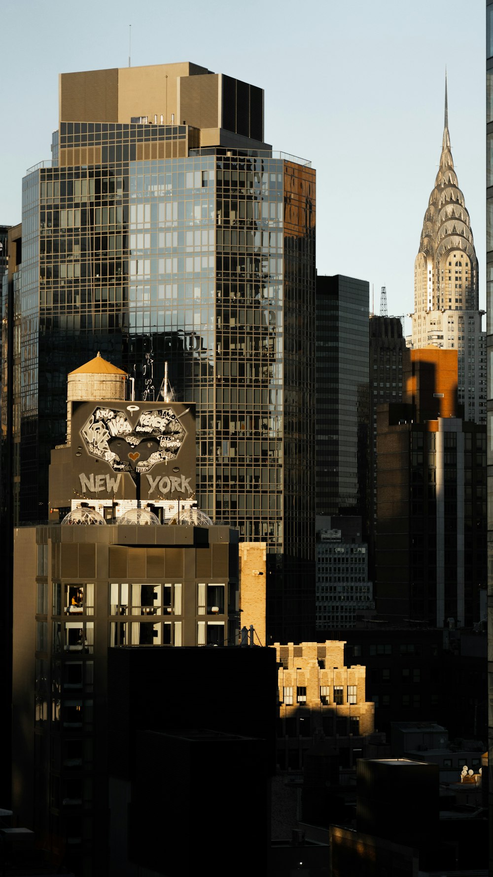 a city skyline with tall buildings and a clock tower