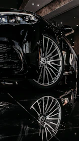 a black sports car parked in a showroom