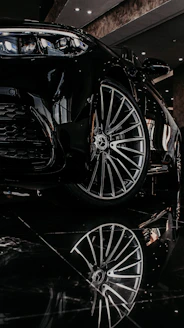 a black sports car parked in a showroom
