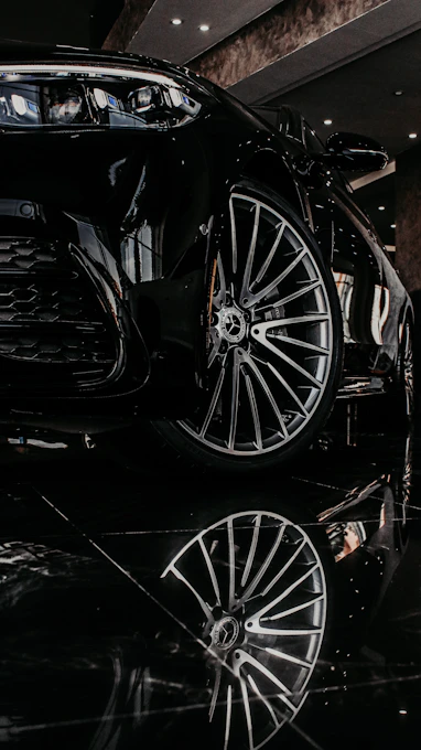 a black sports car parked in a showroom