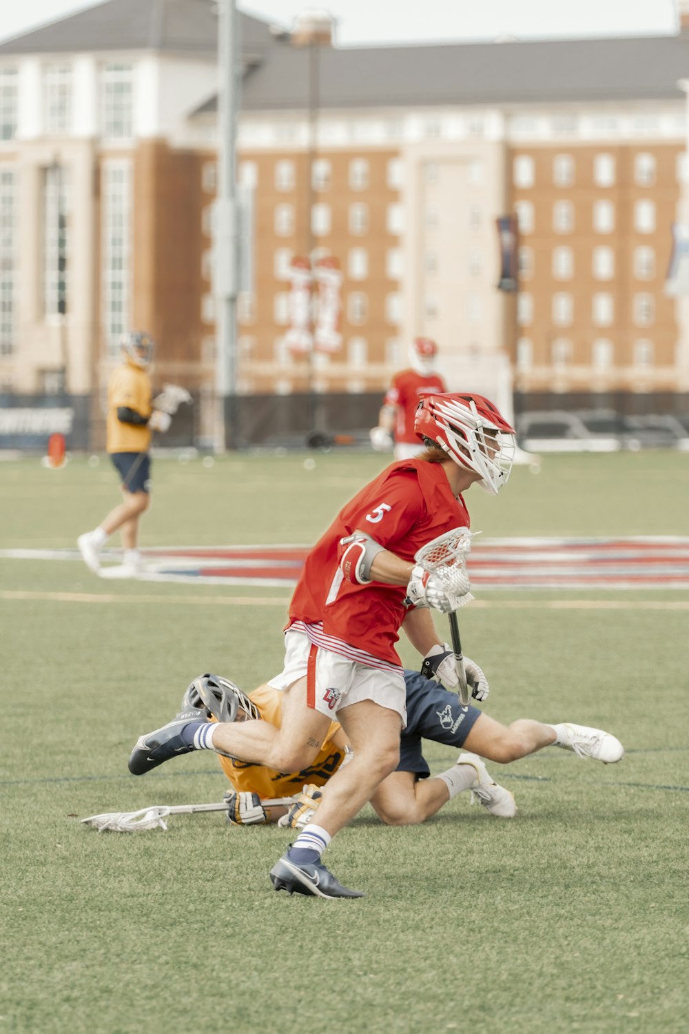 a group of people playing a game of lacrosse