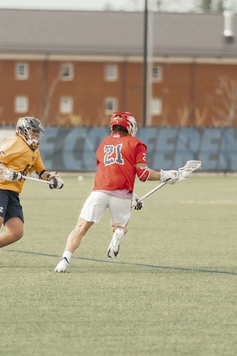 a couple of men playing a game of lacrosse