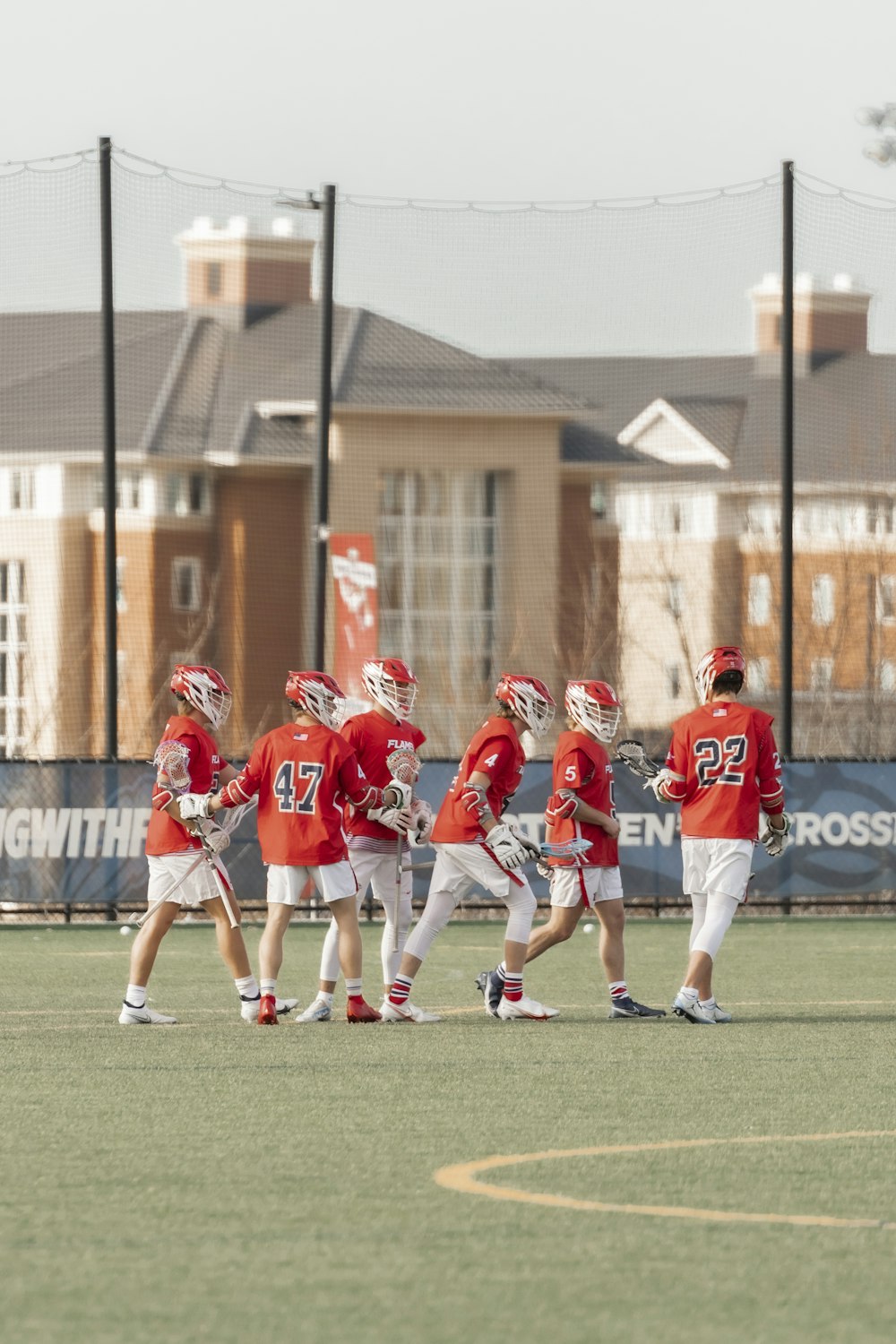 a group of young men standing on top of a field