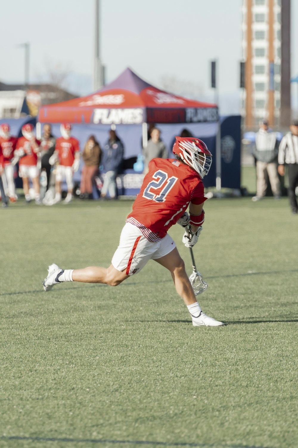 a man holding a lacrosse ball on a field