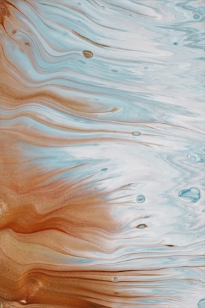 Detailed fluid art with wavy lines blending shades of blue, white, and brown. The mix creates a marbled effect with small variations in texture and depth, resembling ocean waves or marble patterns.