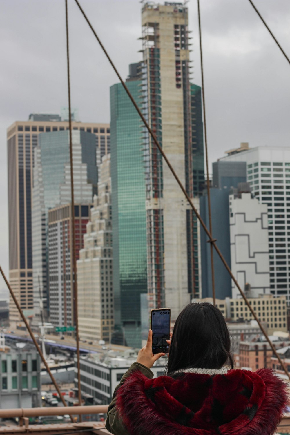 a woman is taking a picture of the city