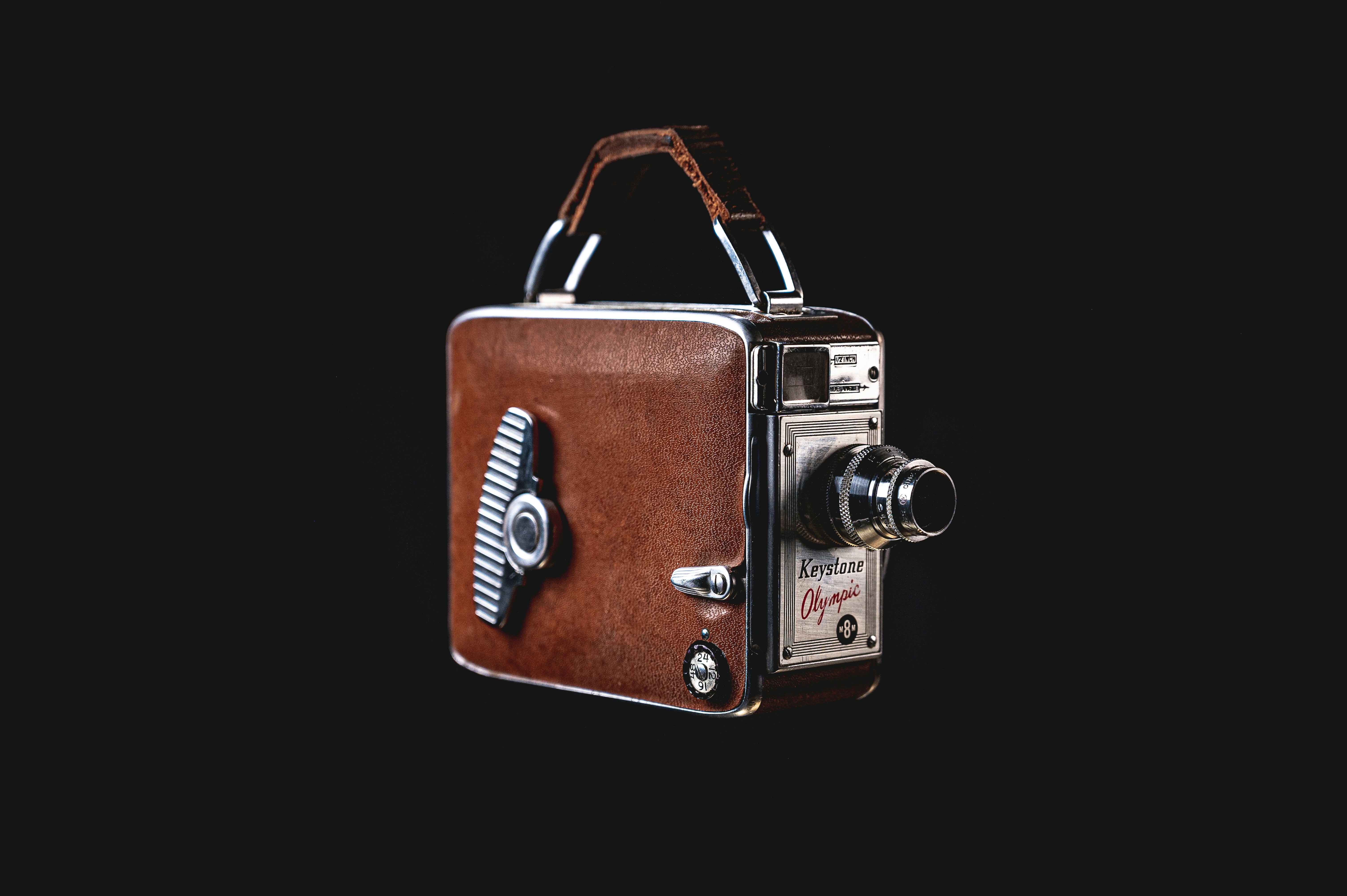 an old fashioned camera with a leather case