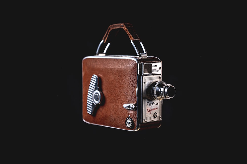 an old fashioned camera with a leather case