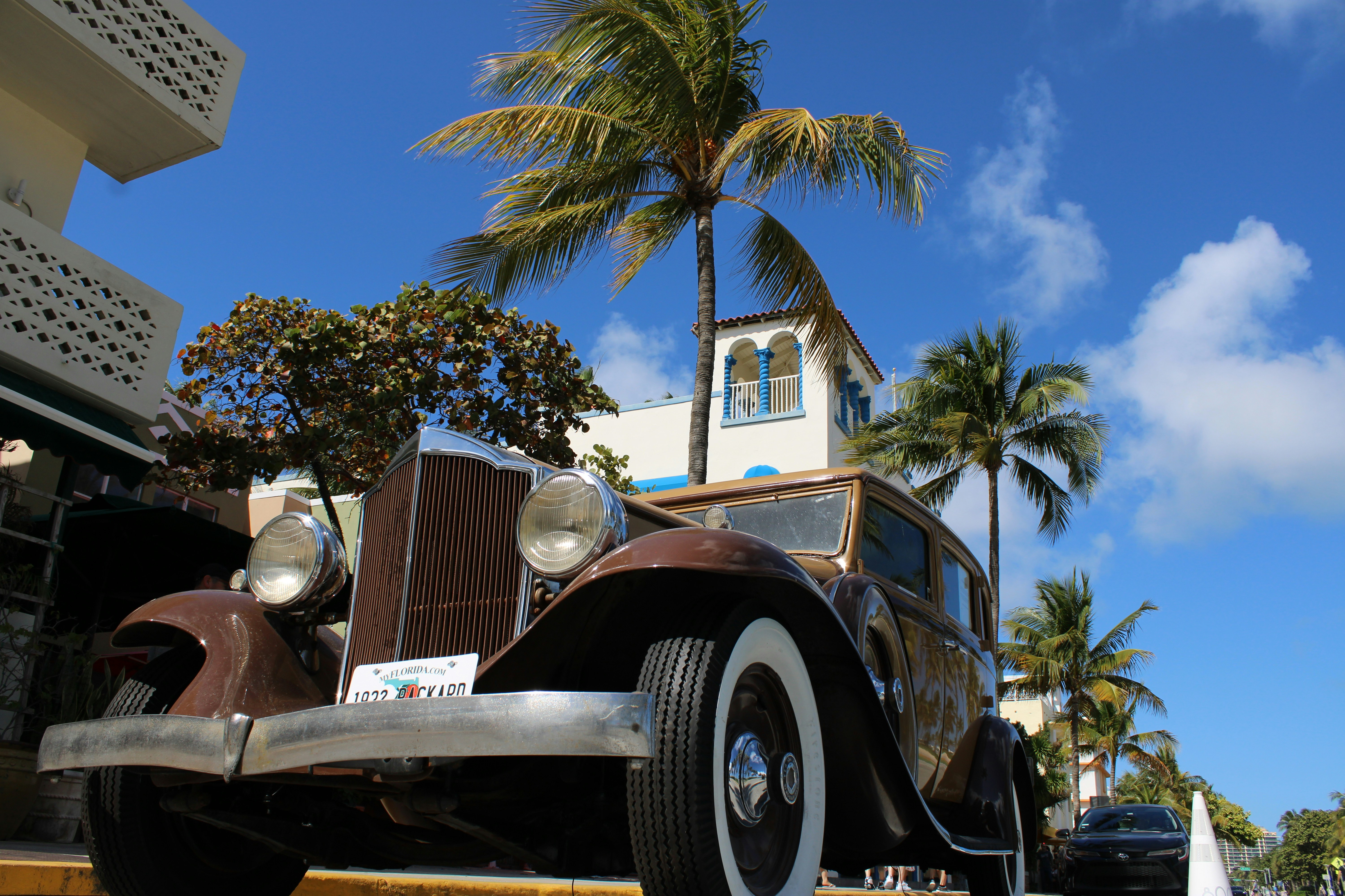 an old car parked in front of a church