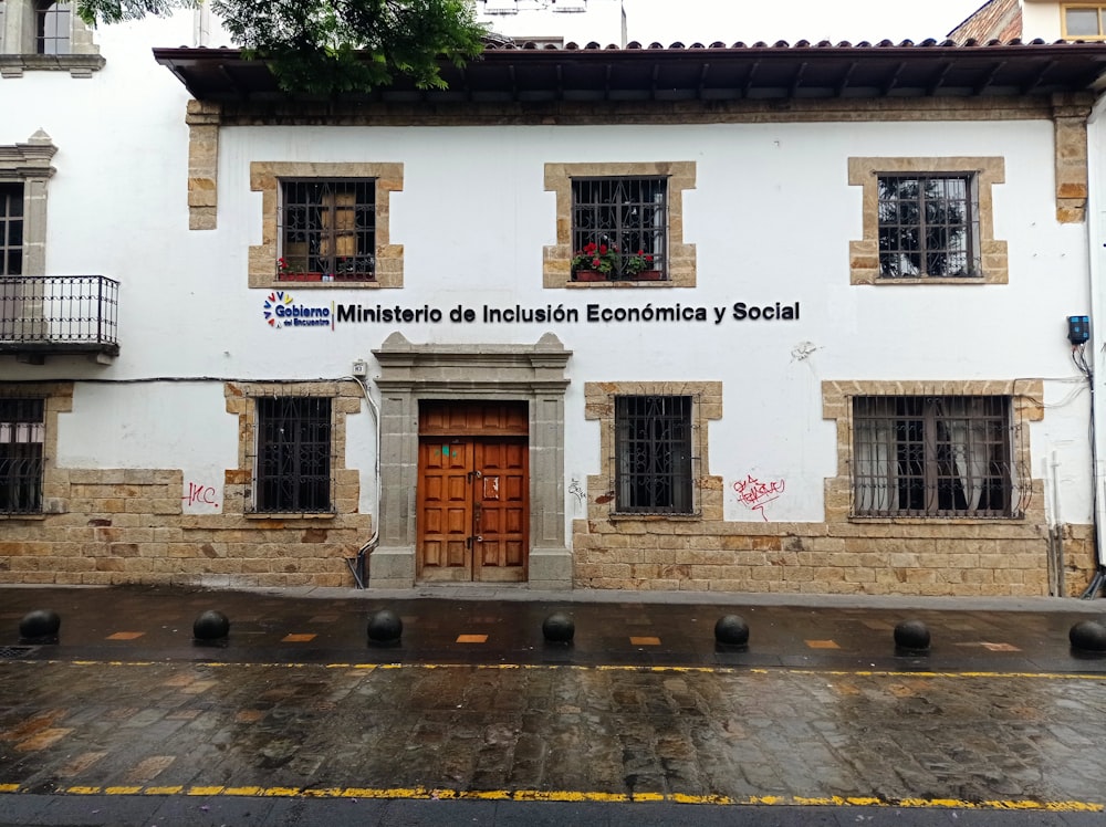 a white building with a wooden door and windows