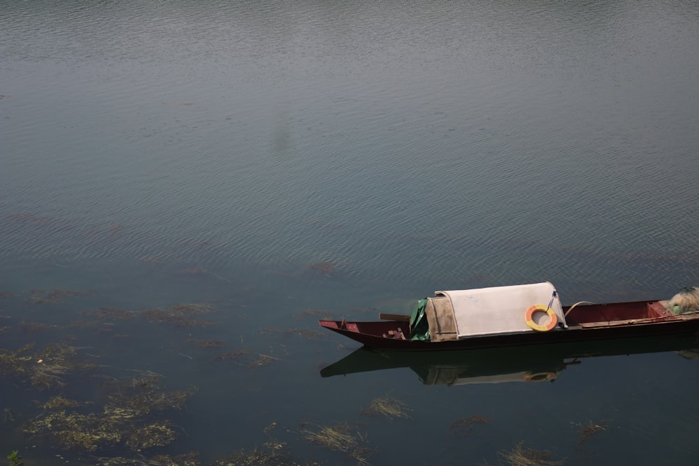 a small boat floating on top of a lake