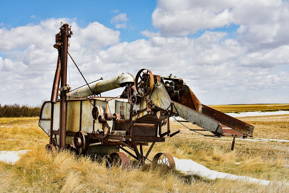 a rusted out machine sitting in a field