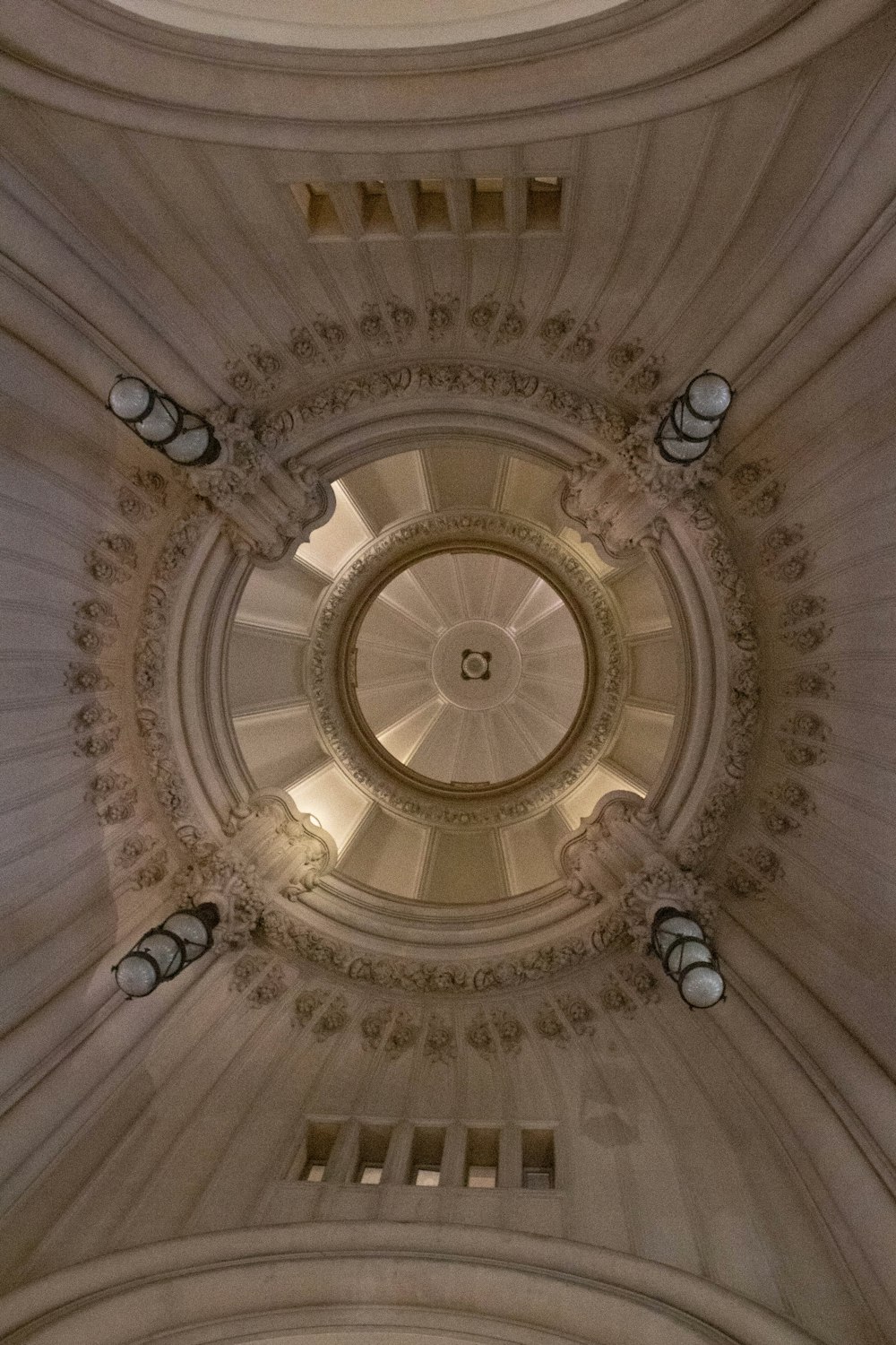 the ceiling of a building with a circular window