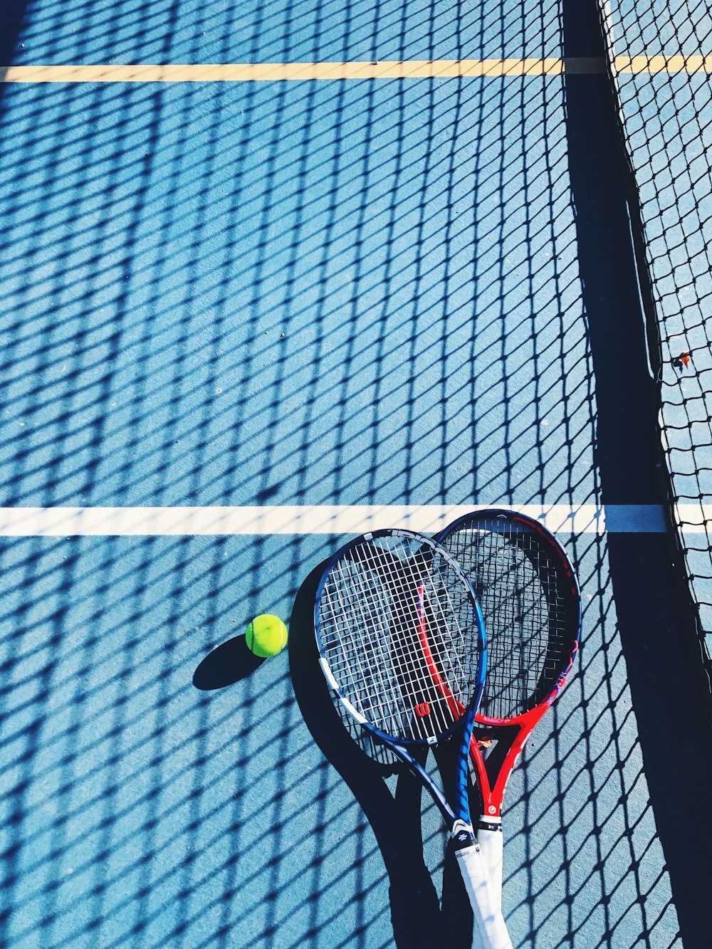 a tennis racket and ball on a tennis court