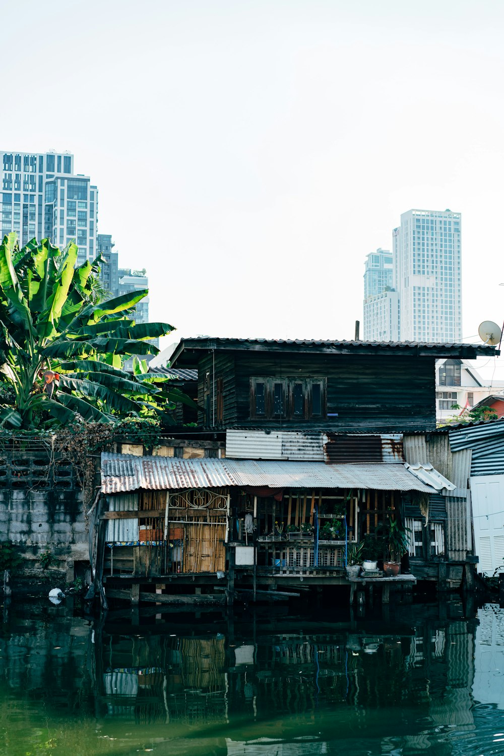 a house sitting on the side of a body of water