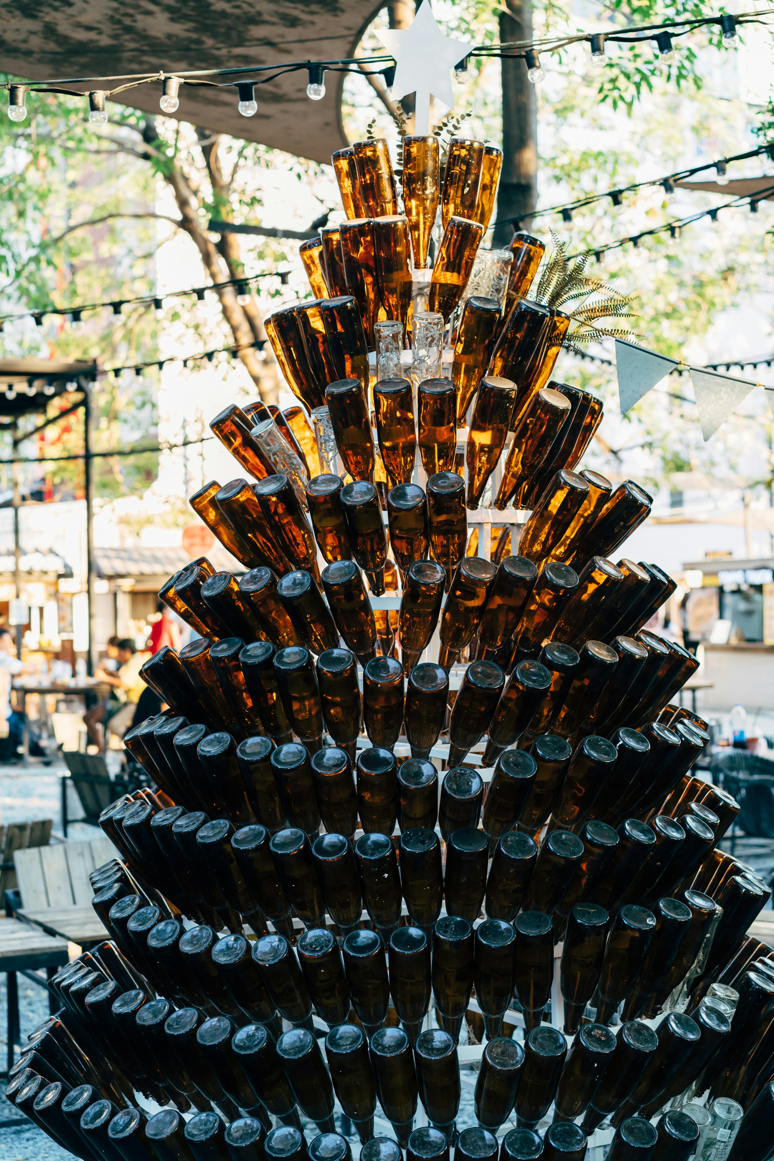 A large display of beer bottles on a table photo Free Bangkok Image