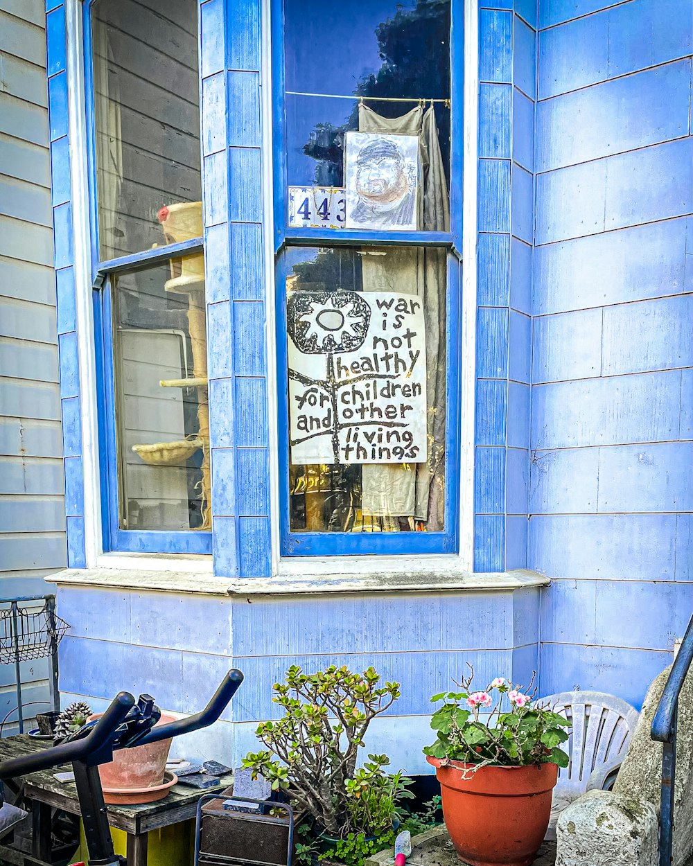 a bicycle parked in front of a blue building