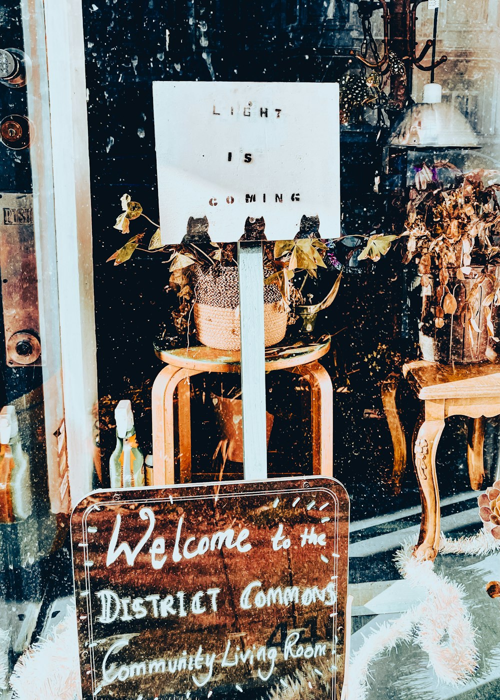 a welcome sign in front of a store window