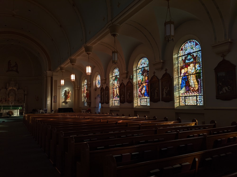 a church with stained glass windows and pews