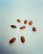 Fresh almonds being carefully selected by hand in a sunlit warehouse.