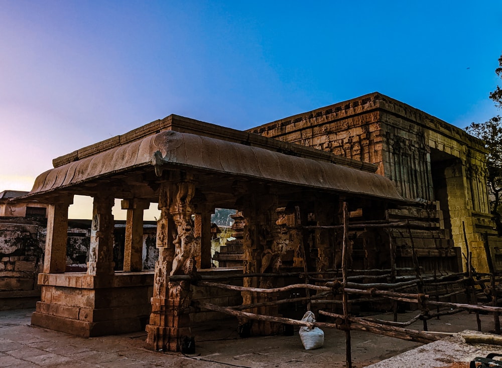 an old building with a wooden fence around it