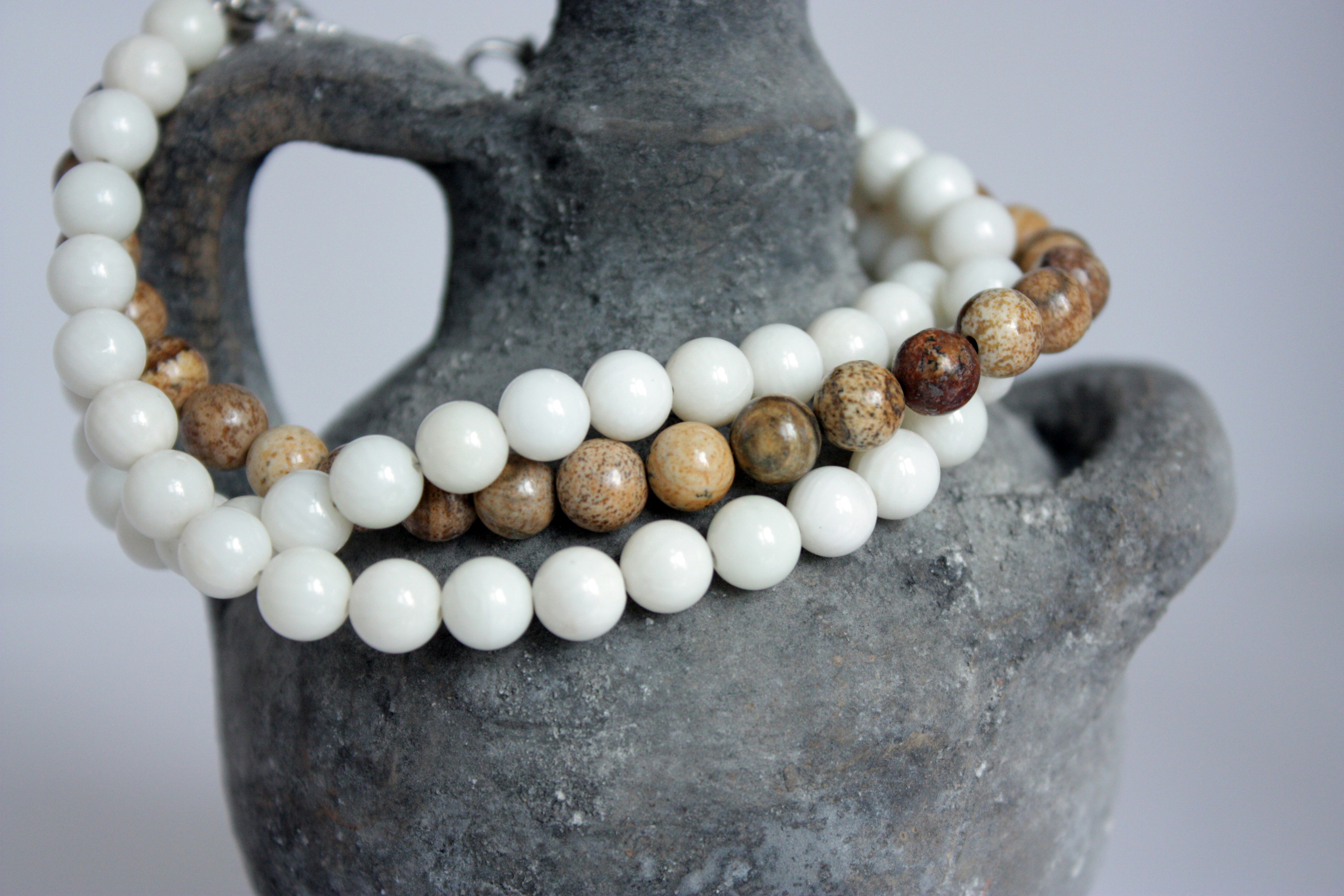 a couple of bracelets sitting on top of a vase