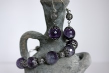 a close up of a pair of purple beads