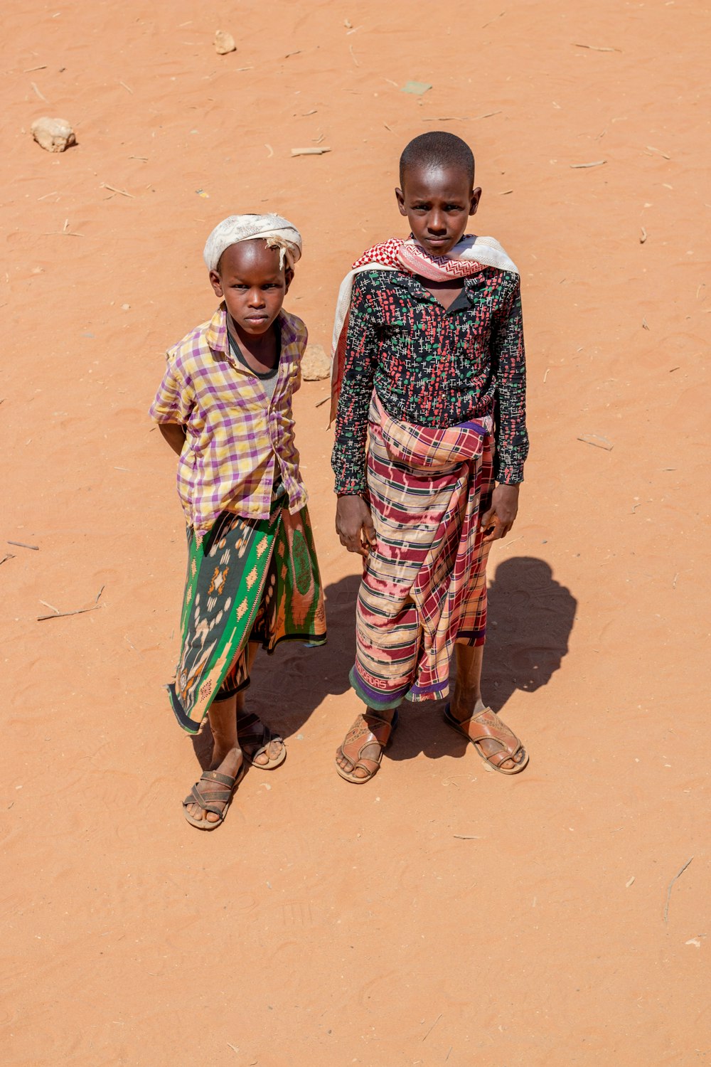 two young children standing in the dirt