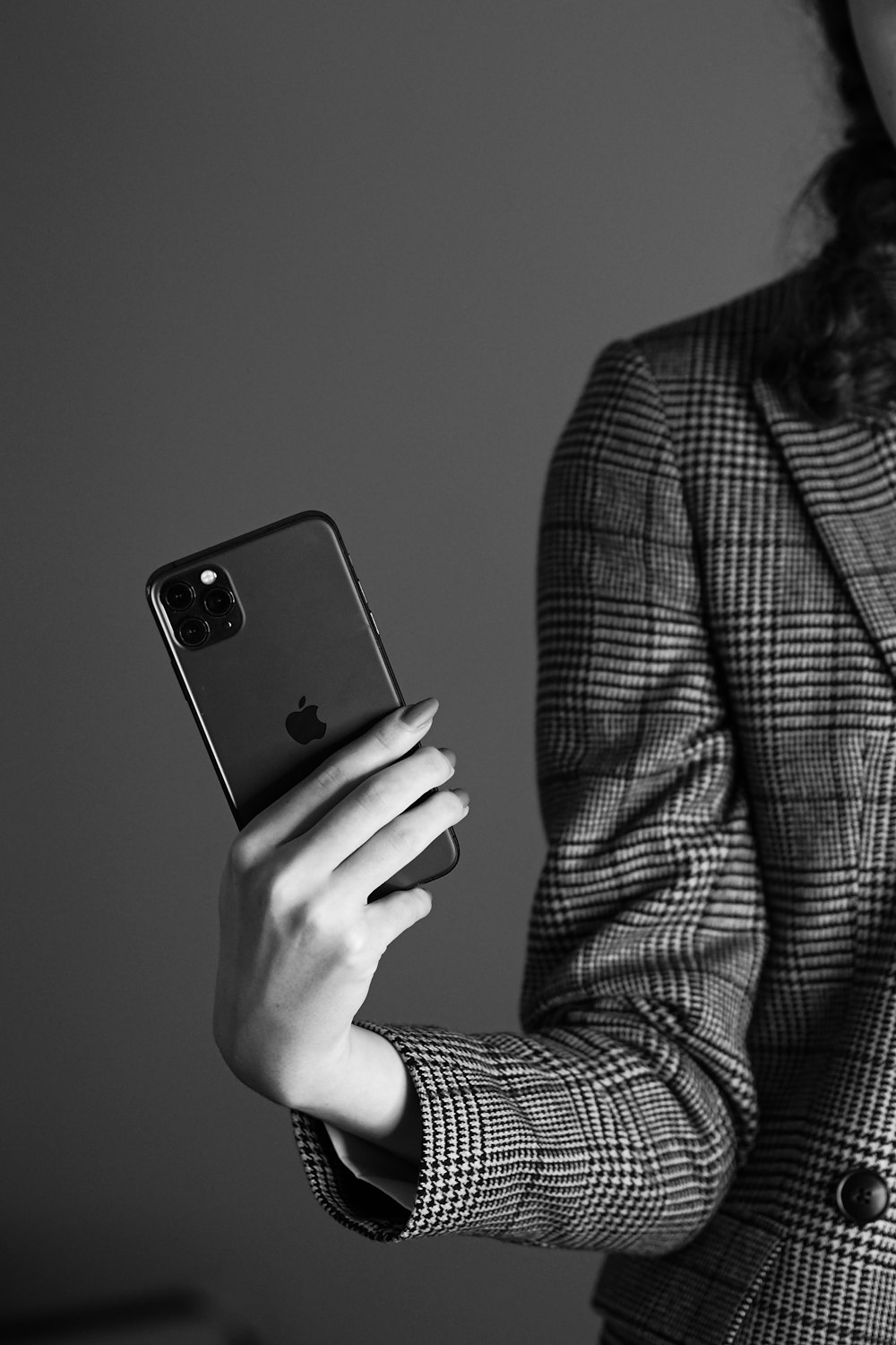 a woman in a suit holding a cell phone