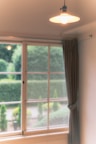 A peaceful garden retreat room with soft lighting and greenery visible outside.
