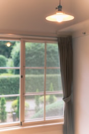 A peaceful garden retreat room with soft lighting and greenery visible outside.