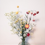a vase filled with lots of different types of flowers