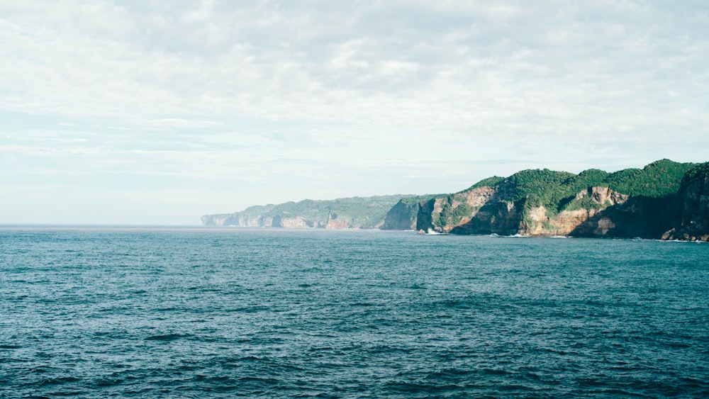 a body of water with a mountain in the background